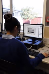 A Rosehill College staff member supporting a student with their learning